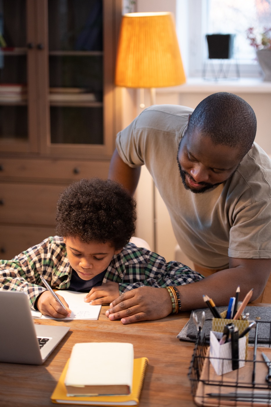 Nigerian parent and child studying together at home
